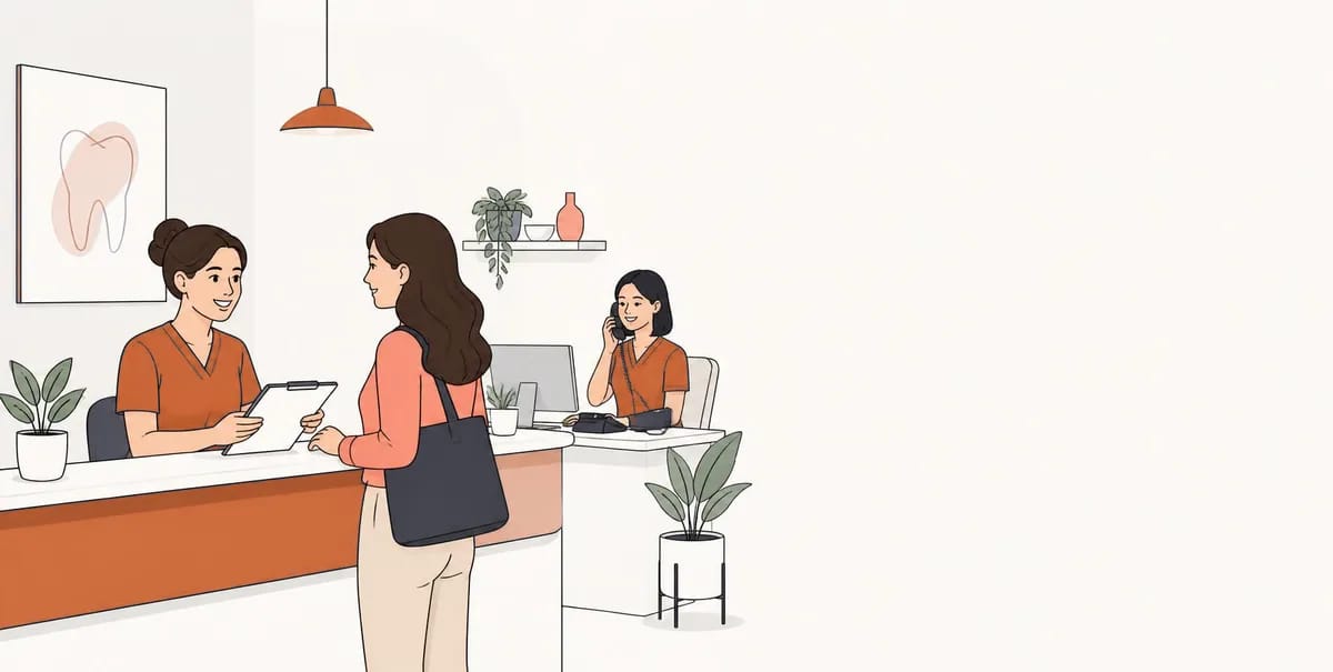 A dental practice reception desk, with one team member greeting a patient and another taking a phone call